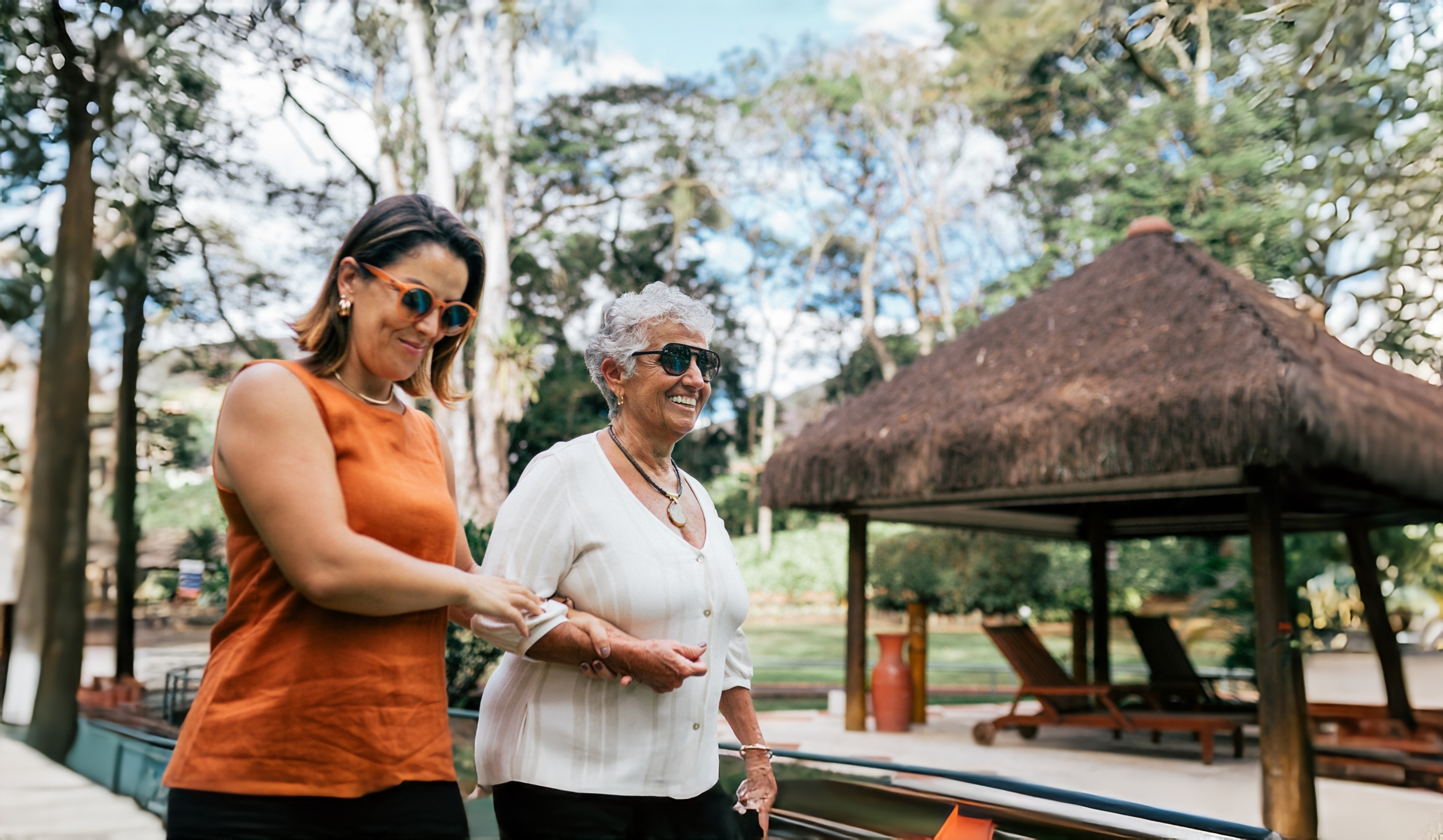 Woman walking arm and arm with her elderly mother